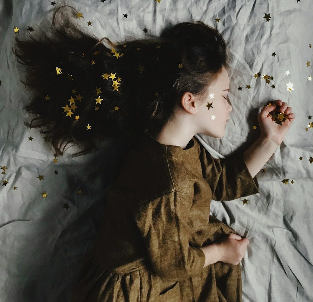 woman in brown long-sleeved top sleeping on bed