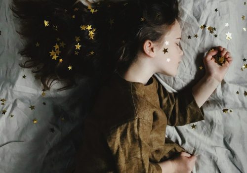 woman in brown long-sleeved top sleeping on bed